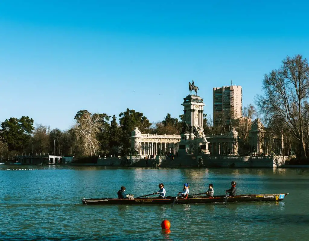 Group of people rowing on Madrid lake